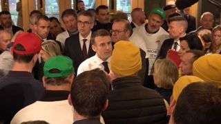 Emmanuel Macron échangeant avec des agriculteurs le 24 février 2024 au Salon de l'agriculture.