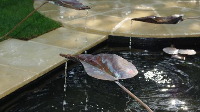 08. Après la mise en eau, j'essaie la fontainerie : des feuilles en cuivre s'échappe de l'eau pour créer du mouvement dans le bassin.
©Art des jardins.